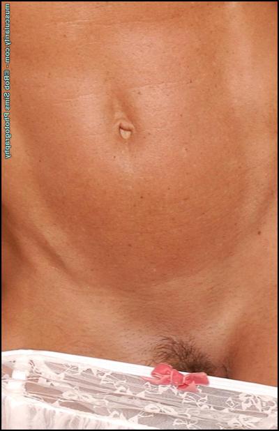 15P Blonde bodybuilder Dena Anne removes white lingerie in a sensual manner
