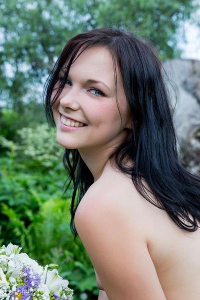 16P Petite teen Yvonne models totally naked on a wooden chair in the garden