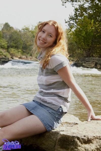 20P American ginger Nicki Blue stripping naked and posing nude by the river