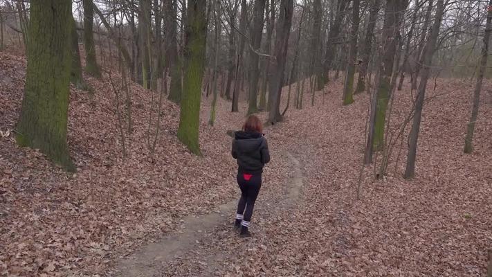 15P Natural redhead Sandra pees on a leaf strewn path while wearing glasses