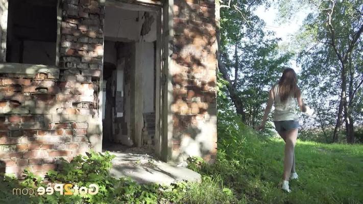 15P Caucasian girl Vika takes a pee in the doorway of an abandoned building