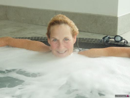 16P Mature blonde Molly MILF sinks into a hot tub while wearing lingerie