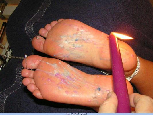 12P Caucasian female has the soles of her feet covered in hot candle wax