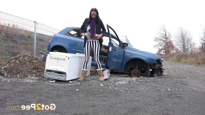 15P Eveline Neill squats for a piss beside a disabled automobile