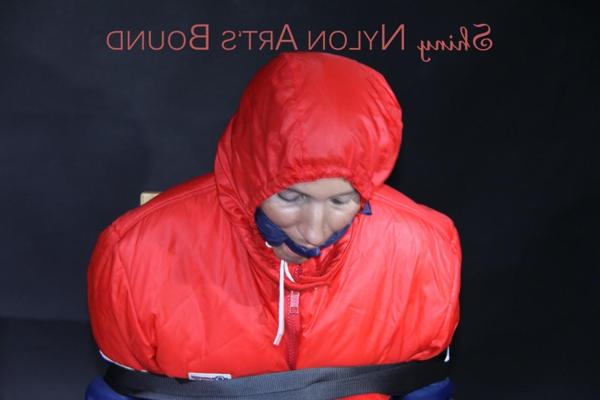16P White girl is tied to a chair in an oldschool down skibib and a down jacket