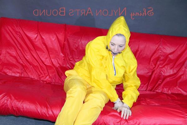 16P White girl is restrained with cuffs and chain while gagged in nylon attire